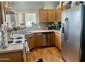 This well-lit kitchen features white and stainless steel appliances and wood cabinets at 2311 E Hartford Ave # 38, Phoenix, AZ 85022