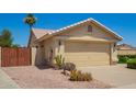 Single story home featuring a two-car garage and desert landscaping at 2409 S Chestnut Pl, Chandler, AZ 85286