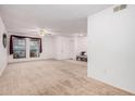 Spacious living room with plush carpeting, neutral paint, and a ceiling fan for added comfort at 2956 E Concho Ave, Mesa, AZ 85204