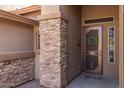 View of the home's entrance featuring a decorative door and beautiful stone accents at 2990 N Pearl Ct, Casa Grande, AZ 85122