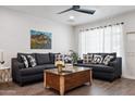 Spacious living room featuring matching sofas, modern decor, wood floors, and a large window at 3814 N 36Th St, Phoenix, AZ 85018