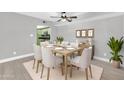 Dining room features a ceiling fan, and a table set for dinner next to a picture window at 3825 E Camelback Rd # 182, Phoenix, AZ 85018
