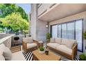 Cozy outdoor patio area with comfortable seating, grill, and privacy wall perfect for relaxation at 3825 E Camelback Rd # 182, Phoenix, AZ 85018