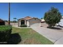 Charming home with a two-car garage, mature trees, and a well-kept lawn at 3897 E Douglas Loop, Gilbert, AZ 85234