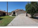A single-story home with a desert landscape, two-car garage, and concrete driveway at 3897 E Douglas Loop, Gilbert, AZ 85234