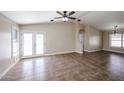 Spacious living room with tile flooring, neutral paint, and a ceiling fan at 3897 E Douglas Loop, Gilbert, AZ 85234