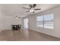 Open living space with light wood floors, dining table, and sliding glass door at 4644 W Havasupai Dr, Glendale, AZ 85308