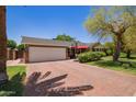 Home featuring a two-car garage and a long red brick driveway leading up to the property at 4710 N 33Rd Pl, Phoenix, AZ 85018