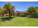 Property showcasing a well-maintained lawn, mature trees, and charming home exterior at 4710 N 33Rd Pl, Phoenix, AZ 85018