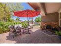 Inviting outdoor patio area with comfortable seating under a large red umbrella at 4710 N 33Rd Pl, Phoenix, AZ 85018