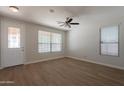 Bright living room with neutral walls, laminate flooring, and windows allowing natural light at 9074 W Runion Dr, Peoria, AZ 85382