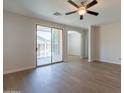 Spacious living area with wood-look floors and sliding glass doors to the covered patio at 9074 W Runion Dr, Peoria, AZ 85382