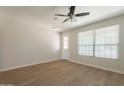 Bright living room with neutral walls, laminate flooring, and windows allowing natural light at 9074 W Runion Dr, Peoria, AZ 85382