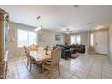 Open-concept dining and living room with tile flooring and ample natural light at 9337 W Medlock Dr, Glendale, AZ 85305