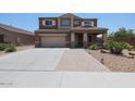 Charming two-story home with a two-car garage, desert landscaping, and covered entry at 9337 W Medlock Dr, Glendale, AZ 85305