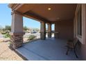 Inviting covered porch with stone accents, providing a cozy outdoor seating area at 9337 W Medlock Dr, Glendale, AZ 85305
