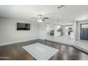 Open-concept living room with hardwood floors and seamless kitchen access at 1066 E 7Th Pl, Mesa, AZ 85203