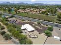 Overhead view of a desert landscaped home featuring an outdoor seating area and a fenced pool, located near a road at 11041 N Hayden Rd, Scottsdale, AZ 85260