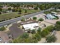 Aerial view of a single-story house with desert landscaping, large driveway, outdoor seating, and fenced pool at 11041 N Hayden Rd, Scottsdale, AZ 85260