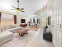 Open-concept living area with vaulted ceilings, tile flooring, and contemporary decor at 12770 W Alvarado Rd, Avondale, AZ 85392