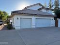 Two-car garage with ample parking space on a concrete driveway, blending functionality with curb appeal at 1454 E Calle De Arcos --, Tempe, AZ 85284