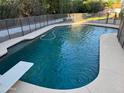 Inviting backyard pool with diving board and a safety fence, perfect for relaxation and recreation at 1454 E Calle De Arcos --, Tempe, AZ 85284