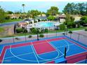 Aerial view showcasing the community pool, sport court, and well-maintained landscaping at 1550 N Stapley Dr # 95, Mesa, AZ 85203