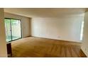 Bright living room featuring neutral walls, carpet, and a sliding glass door at 1550 N Stapley Dr # 95, Mesa, AZ 85203