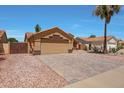Attractive single-story home with desert landscaping, tile roof, and brick paved driveway at 18130 N 92Nd Ln, Peoria, AZ 85382