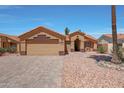 Welcoming single-story home with desert landscaping, tile roof, and a two car garage at 18130 N 92Nd Ln, Peoria, AZ 85382