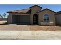 Single-story home with a two-car garage and desert landscaping at 18941 W Monterosa St, Litchfield Park, AZ 85340