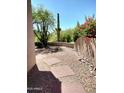 Desert landscaped courtyard with gravel, cacti, stepping stones and blooming bougainvillea at 25150 N Windy Walk Dr # 14, Scottsdale, AZ 85255