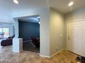 Open-concept floorplan from the entryway featuring tile floors and views into the living spaces at 26243 W Wahalla Ln, Buckeye, AZ 85396