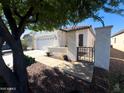 Attractive home featuring desert landscaping, a gated front entry, and a well-maintained front yard at 26243 W Wahalla Ln, Buckeye, AZ 85396