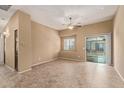 Neutral living room with a ceiling fan, window, and sliding glass door to a covered balcony at 2725 E Mine Creek Rd # 2146, Phoenix, AZ 85024