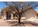 Charming single-story home featuring a two-car garage and covered front porch at 4942 W Novak Way, Laveen, AZ 85339