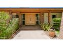 Welcoming entryway with double doors, brick accents, and lush landscaping at 5112 N 32Nd Pl, Phoenix, AZ 85018