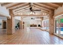 Open-concept living area with Saltillo tile floors, exposed brick beams, and vaulted ceilings at 5112 N 32Nd Pl, Phoenix, AZ 85018