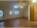 Bright living room with wood floors, ceiling fan, and ample natural light streaming through the window at 5933 E Main St # 1, Mesa, AZ 85206