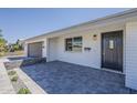 Stylish home exterior featuring updated gray brickwork, a black front door and landscaping at 727 N Beverly --, Mesa, AZ 85201