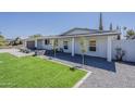 Well-kept single-story home with a lush green lawn and fresh desert landscaping at 727 N Beverly --, Mesa, AZ 85201