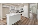 Modern kitchen with an island, stainless steel appliances, and bright white cabinets at 1073 N 159Th Dr, Goodyear, AZ 85338