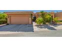 Inviting home exterior with a tile roof, two car garage and well-maintained desert landscaping at 10830 N 11Th St, Phoenix, AZ 85020