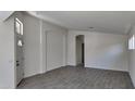 Open-concept living area with gray wood-look tile flooring and fresh white paint at 11342 W Barbara Ave, Peoria, AZ 85345