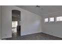 Bright, airy living room featuring gray wood-look tile and access to the outdoor patio at 11342 W Barbara Ave, Peoria, AZ 85345