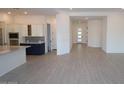 Bright living room showcasing hardwood floors, neutral paint, and open concept with the kitchen at 12323 W Luxton Ln, Avondale, AZ 85323