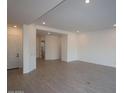 Open-concept living room featuring recessed lighting, hardwood floors, and neutral paint at 12323 W Luxton Ln, Avondale, AZ 85323