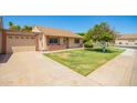 Well-maintained single-story home with attached garage, lawn, and mature landscaping under a clear blue sky at 160 Leisure World -- # 160, Mesa, AZ 85206