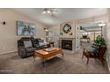 This living room features a ceiling fan, a fireplace, and comfortable seating at 1719 E Sandalwood Rd, Casa Grande, AZ 85122