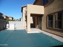 Backyard covered with green surface including a covered patio and privacy block fence at 18548 W Sunbelt Dr, Surprise, AZ 85374
